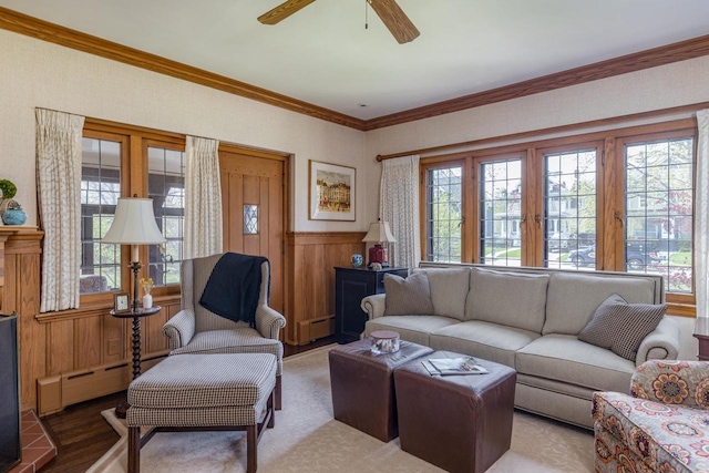 1030 Washington Ave, Oshkosh, WI 54901 - living room with ornamental molding, a baseboard radiator, wainscoting, ceiling fan, and baseboard heating