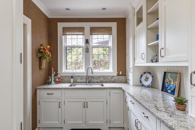 1030 Washington Ave, Oshkosh, WI 54901 - kitchen featuring a sink, white cabinets, ornamental molding, open shelves, and light stone countertops