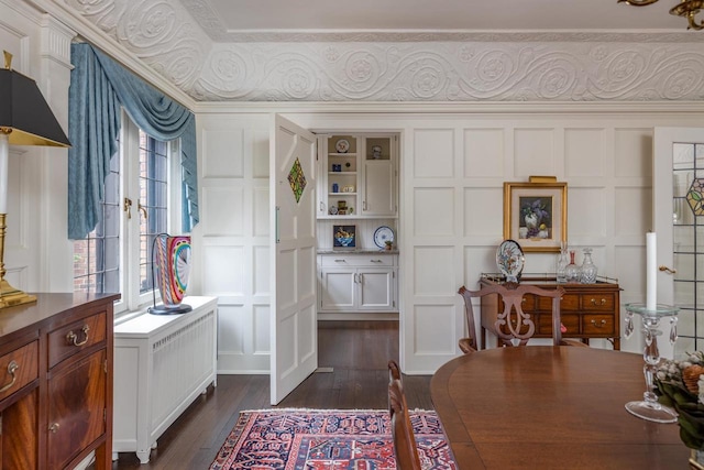 1030 Washington Ave, Oshkosh, WI 54901 - dining room featuring a decorative wall, dark wood-style flooring, and ornamental molding