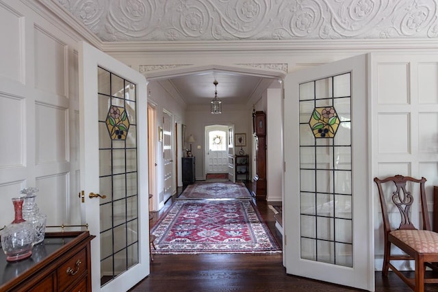 1030 Washington Ave, Oshkosh, WI 54901 - foyer featuring ornamental molding, dark wood-style flooring, french doors, and baseboards