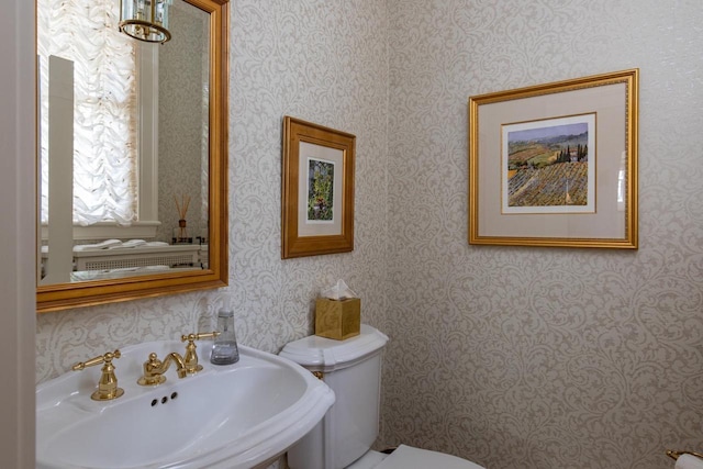 1030 Washington Ave, Oshkosh, WI 54901 - bathroom with toilet, wallpapered walls, and a sink