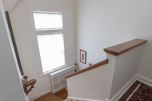1030 Washington Ave, Oshkosh, WI 54901 - staircase with radiator, plenty of natural light, wood finished floors, and baseboards