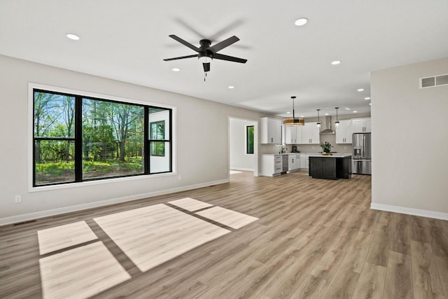 11715 45th Ave, Pleasant Prairie, WI 53158 - unfurnished living room featuring recessed lighting, a ceiling fan, light wood finished floors, and baseboards