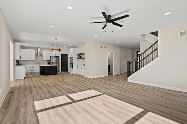 11715 45th Ave, Pleasant Prairie, WI 53158 - unfurnished living room featuring baseboards, light wood-type flooring, ceiling fan, stairway, and recessed lighting