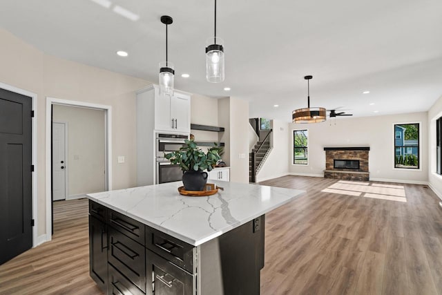 11715 45th Ave, Pleasant Prairie, WI 53158 - kitchen with plenty of natural light, a stone fireplace, light wood-type flooring, and recessed lighting