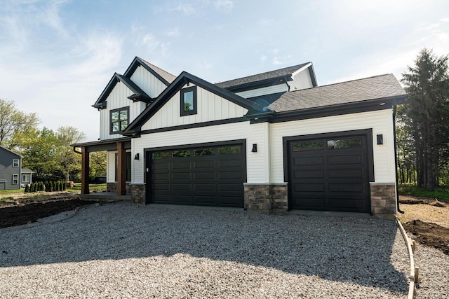 11715 45th Ave, Pleasant Prairie, WI 53158 - view of front of house with driveway, stone siding, and board and batten siding