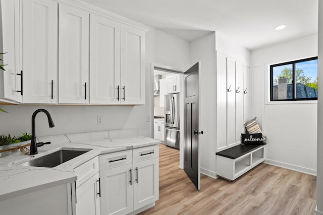 11715 45th Ave, Pleasant Prairie, WI 53158 - kitchen featuring stainless steel fridge with ice dispenser, light wood-style floors, a sink, white cabinets, and light stone counters