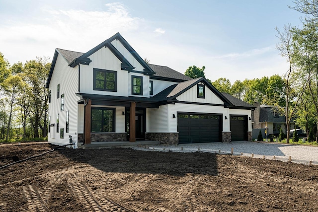 11715 45th Ave, Pleasant Prairie, WI 53158 - modern farmhouse style home featuring a porch, board and batten siding, driveway, an attached garage, and stone siding