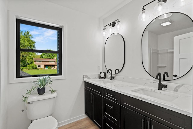 11715 45th Ave, Pleasant Prairie, WI 53158 - full bath featuring double vanity, toilet, baseboards, and wood finished floors