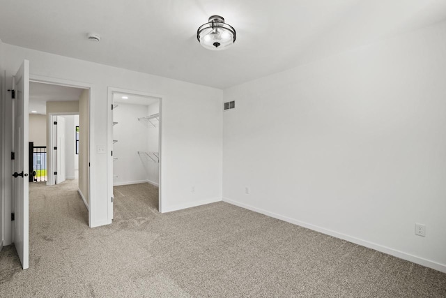 11715 45th Ave, Pleasant Prairie, WI 53158 - unfurnished bedroom with carpet, a spacious closet, baseboards, and a closet