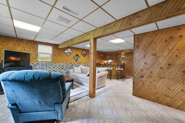 812 Clover Ln, Deforest, WI 53532 - living room featuring wood walls, carpet flooring, and a paneled ceiling