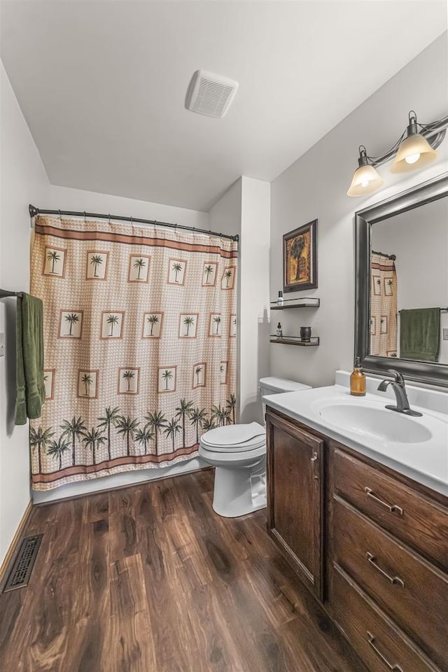 812 Clover Ln, Deforest, WI 53532 - bathroom featuring toilet, wood finished floors, vanity, and curtained shower