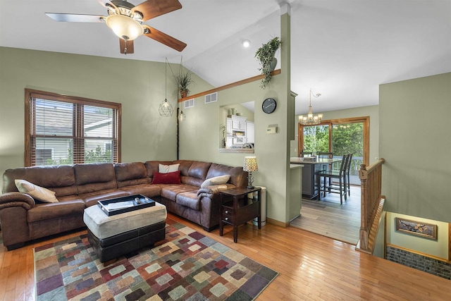 812 Clover Ln, Deforest, WI 53532 - living room with vaulted ceiling, a chandelier, hardwood / wood-style flooring, a ceiling fan, and baseboards