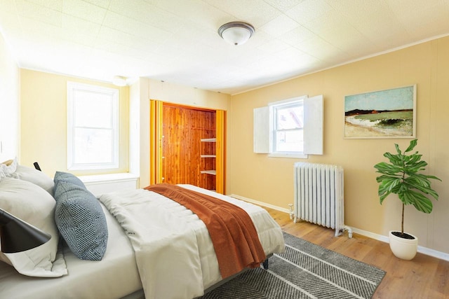 1031 S 15th St, Milwaukee, WI 53204 - bedroom with radiator, wood finished floors, and baseboards