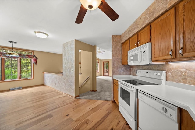 W159N4835 Graysland Dr Unit E, Menomonee Falls, WI 53051 - kitchen featuring white appliances, a ceiling fan, light wood-type flooring, brown cabinetry, and healthy amount of natural light