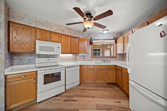 W159N4835 Graysland Dr Unit E, Menomonee Falls, WI 53051 - kitchen with white appliances, a sink, a ceiling fan, light wood-type flooring, and light countertops