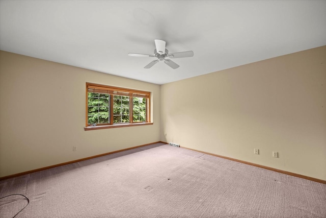 W159N4835 Graysland Dr Unit E, Menomonee Falls, WI 53051 - carpeted spare room featuring a ceiling fan and baseboards