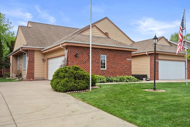 W159N4835 Graysland Dr Unit E, Menomonee Falls, WI 53051 - view of side of home featuring an attached garage, a shingled roof, a lawn, and brick siding