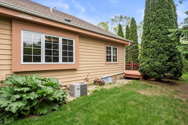 W159N4835 Graysland Dr Unit E, Menomonee Falls, WI 53051 - view of property exterior featuring central AC unit, a lawn, a deck, and a shingled roof
