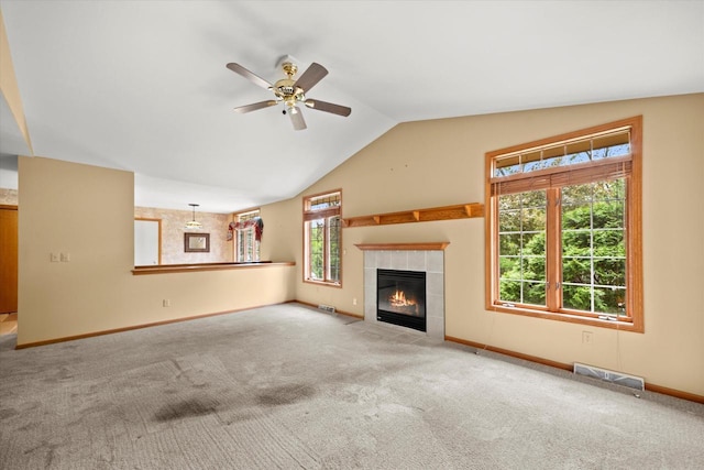 W159N4835 Graysland Dr Unit E, Menomonee Falls, WI 53051 - unfurnished living room with a tiled fireplace, carpet flooring, a ceiling fan, lofted ceiling, and baseboards