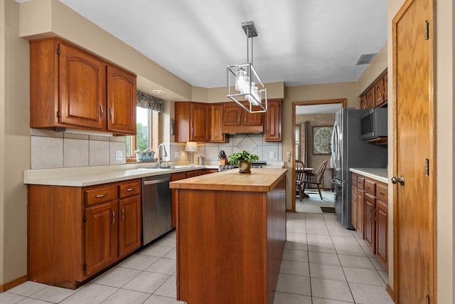 3226 W Twin Willow Ct, Appleton, WI 54914 - kitchen with stainless steel appliances, wooden counters, a center island, a sink, and tasteful backsplash