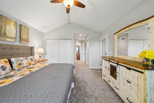 690 Valleyview Ct Unit 35-22, Lake Geneva, WI 53147 - carpeted bedroom featuring two closets, vaulted ceiling, baseboards, and a ceiling fan
