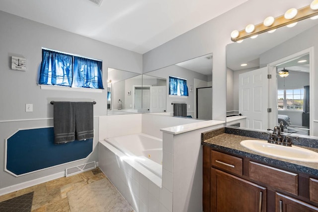 690 Valleyview Ct Unit 35-22, Lake Geneva, WI 53147 - bathroom with a whirlpool tub, a stall shower, vanity, a ceiling fan, and baseboards