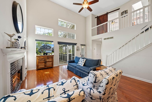 690 Valleyview Ct Unit 35-22, Lake Geneva, WI 53147 - living area featuring baseboards, ceiling fan, a fireplace, stairway, and hardwood / wood-style floors