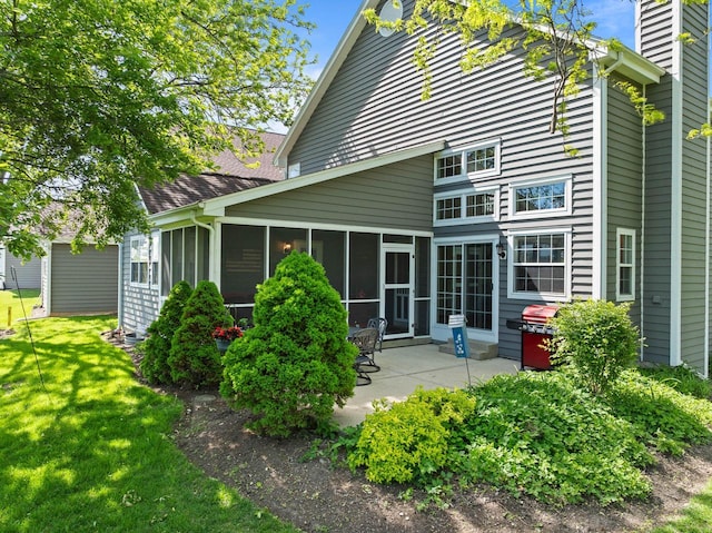 690 Valleyview Ct Unit 35-22, Lake Geneva, WI 53147 - back of property featuring a patio, a sunroom, and a lawn