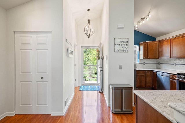 690 Valleyview Ct Unit 35-22, Lake Geneva, WI 53147 - kitchen with dishwasher, wood finished floors, decorative backsplash, baseboards, and a chandelier