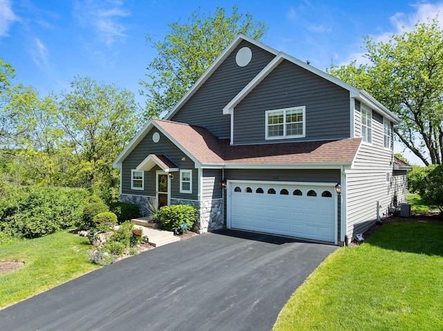 690 Valleyview Ct Unit 35-22, Lake Geneva, WI 53147 - view of front facade featuring asphalt driveway, an attached garage, a front yard, roof with shingles, and central air condition unit