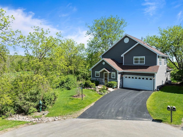 690 Valleyview Ct Unit 35-22, Lake Geneva, WI 53147 - view of front facade with driveway, an attached garage, a front yard, and central AC
