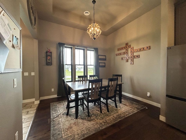 11654 Flambeau Rd, Tomah, WI 54660 - dining room with a chandelier, baseboards, wood finished floors, and a tray ceiling