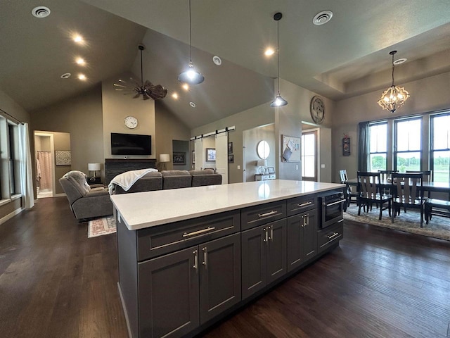 11654 Flambeau Rd, Tomah, WI 54660 - kitchen with dark wood-type flooring, light countertops, pendant lighting, a chandelier, and a center island