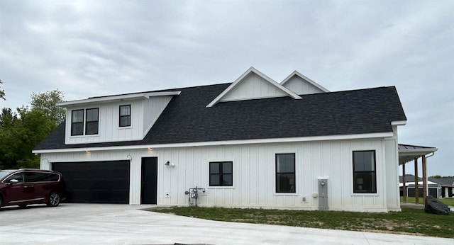 11654 Flambeau Rd, Tomah, WI 54660 - modern farmhouse style home with driveway, board and batten siding, a shingled roof, and an attached garage