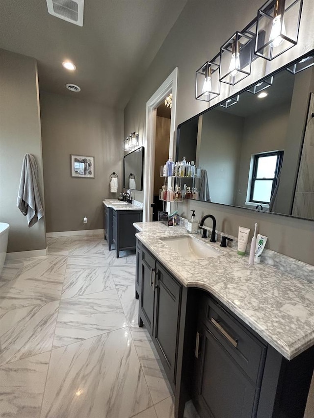 11654 Flambeau Rd, Tomah, WI 54660 - full bath with two vanities, a freestanding bath, and recessed lighting