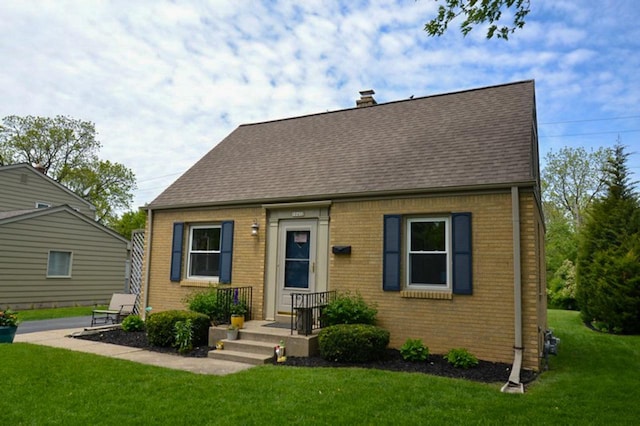 10432 W Manor Park Dr, West Allis, WI 53227 - cape cod-style house with brick siding, a front lawn, and a shingled roof