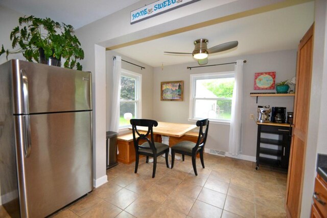 10432 W Manor Park Dr, West Allis, WI 53227 - dining space featuring a ceiling fan, light tile patterned floors, and baseboards