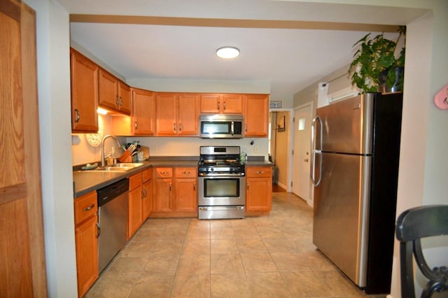 10432 W Manor Park Dr, West Allis, WI 53227 - kitchen with stainless steel appliances, a sink, dark countertops, and light tile patterned floors