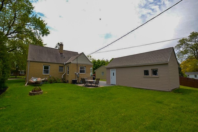 10432 W Manor Park Dr, West Allis, WI 53227 - rear view of property featuring a fire pit, a lawn, a patio area, and a chimney