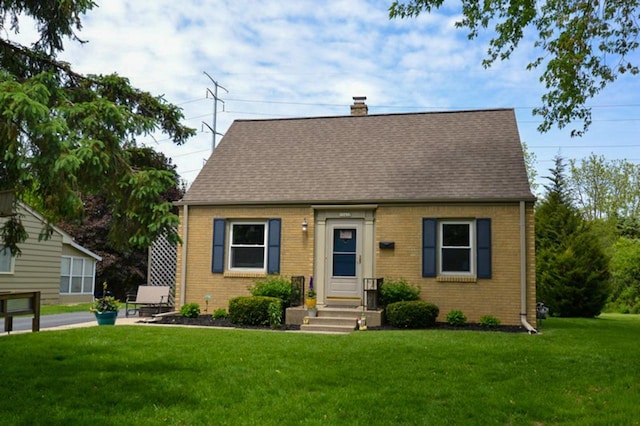 10432 W Manor Park Dr, West Allis, WI 53227 - cape cod house featuring a front lawn, brick siding, roof with shingles, and a chimney