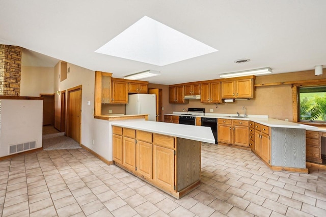 1510 County Road Qq, Mineral Point, WI 53565 - kitchen featuring range with gas stovetop, freestanding refrigerator, a peninsula, and dishwasher