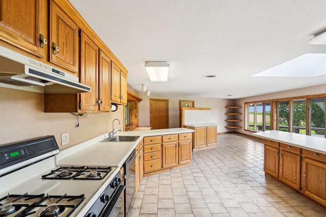1510 County Road Qq, Mineral Point, WI 53565 - kitchen with white gas range oven, under cabinet range hood, a sink, and light countertops