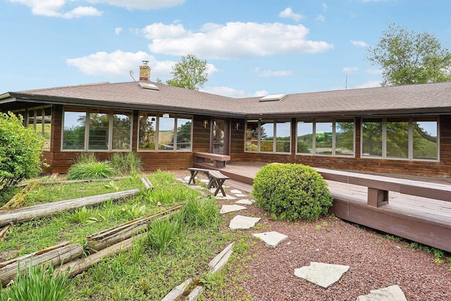 1510 County Road Qq, Mineral Point, WI 53565 - back of house featuring a deck, a shingled roof, and a chimney