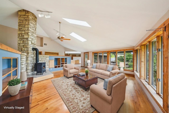 1510 County Road Qq, Mineral Point, WI 53565 - living area featuring a wood stove, a skylight, wood finished floors, track lighting, and ceiling fan
