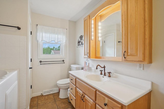 354 Pine Ct, Muscoda, WI 53573 - bathroom with toilet, vanity, a bathtub, tile patterned floors, and baseboards