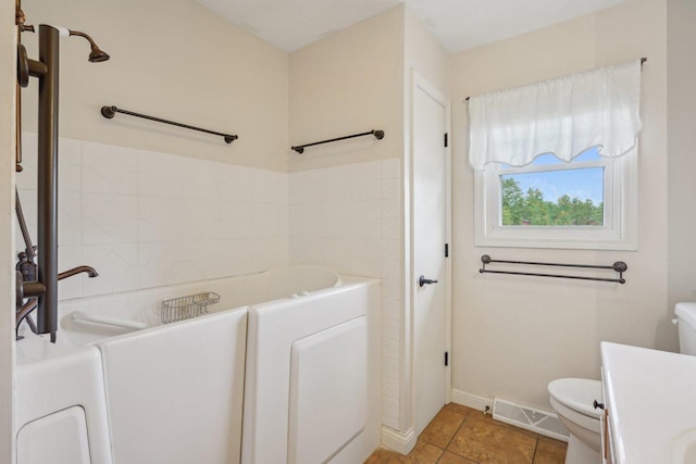 354 Pine Ct, Muscoda, WI 53573 - full bathroom featuring toilet, a bath, vanity, tile patterned floors, and baseboards