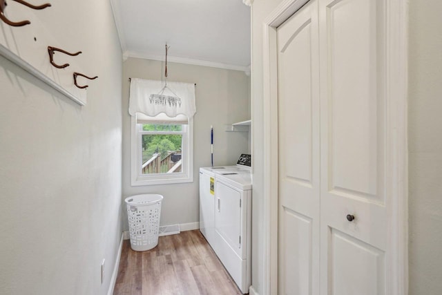 354 Pine Ct, Muscoda, WI 53573 - laundry room featuring ornamental molding, separate washer and dryer, baseboards, and light wood finished floors