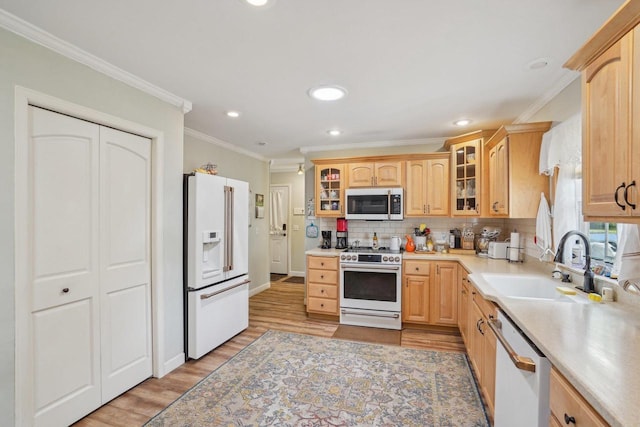 354 Pine Ct, Muscoda, WI 53573 - kitchen featuring white appliances, a sink, light brown cabinetry, crown molding, and light countertops