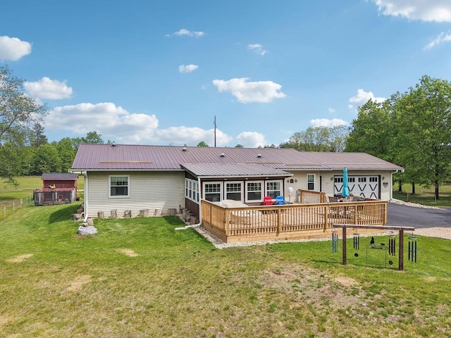 354 Pine Ct, Muscoda, WI 53573 - back of property featuring an attached garage, driveway, metal roof, and a lawn